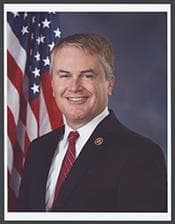 Official portrait of James Comer
